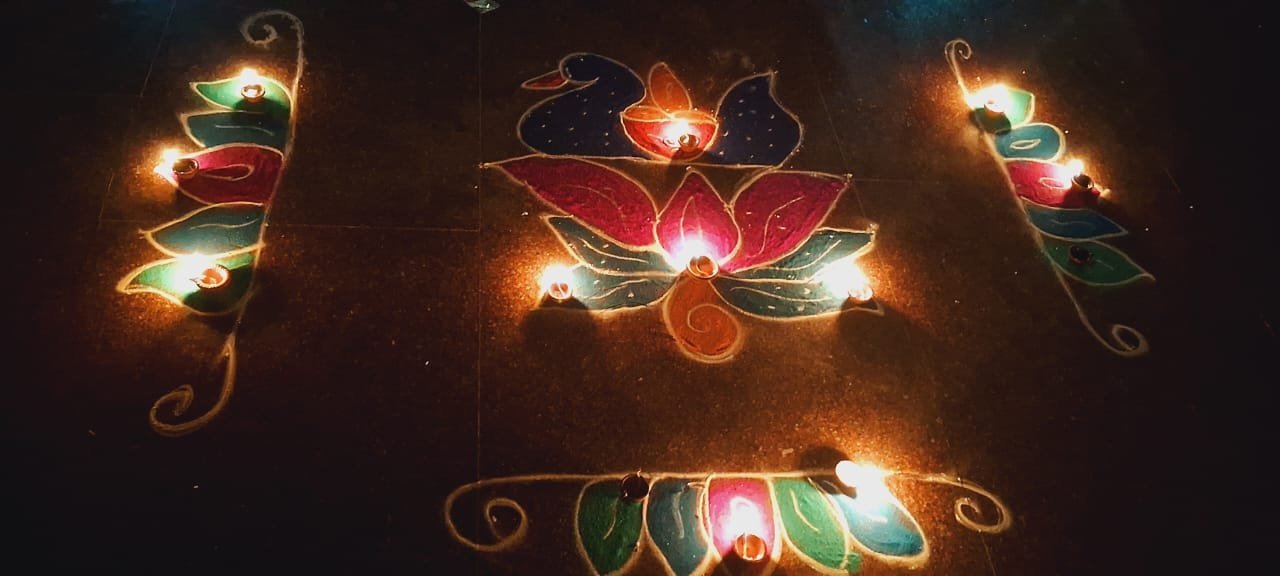 Deepavali lamps arranged in a rangoli at a KAILASA temple